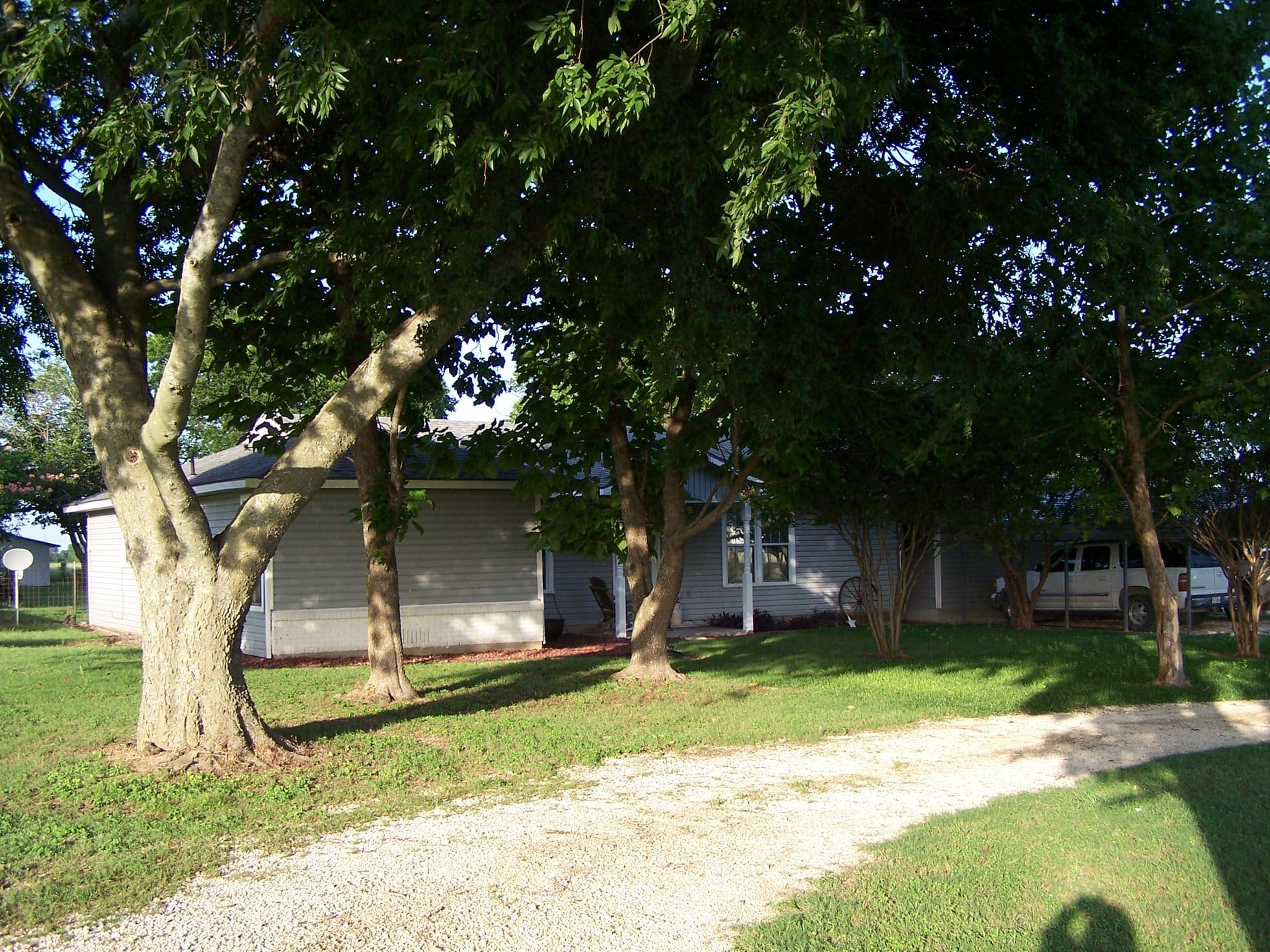 Beautiful Hillsboro house surrounded by mature trees and lush green lawn.