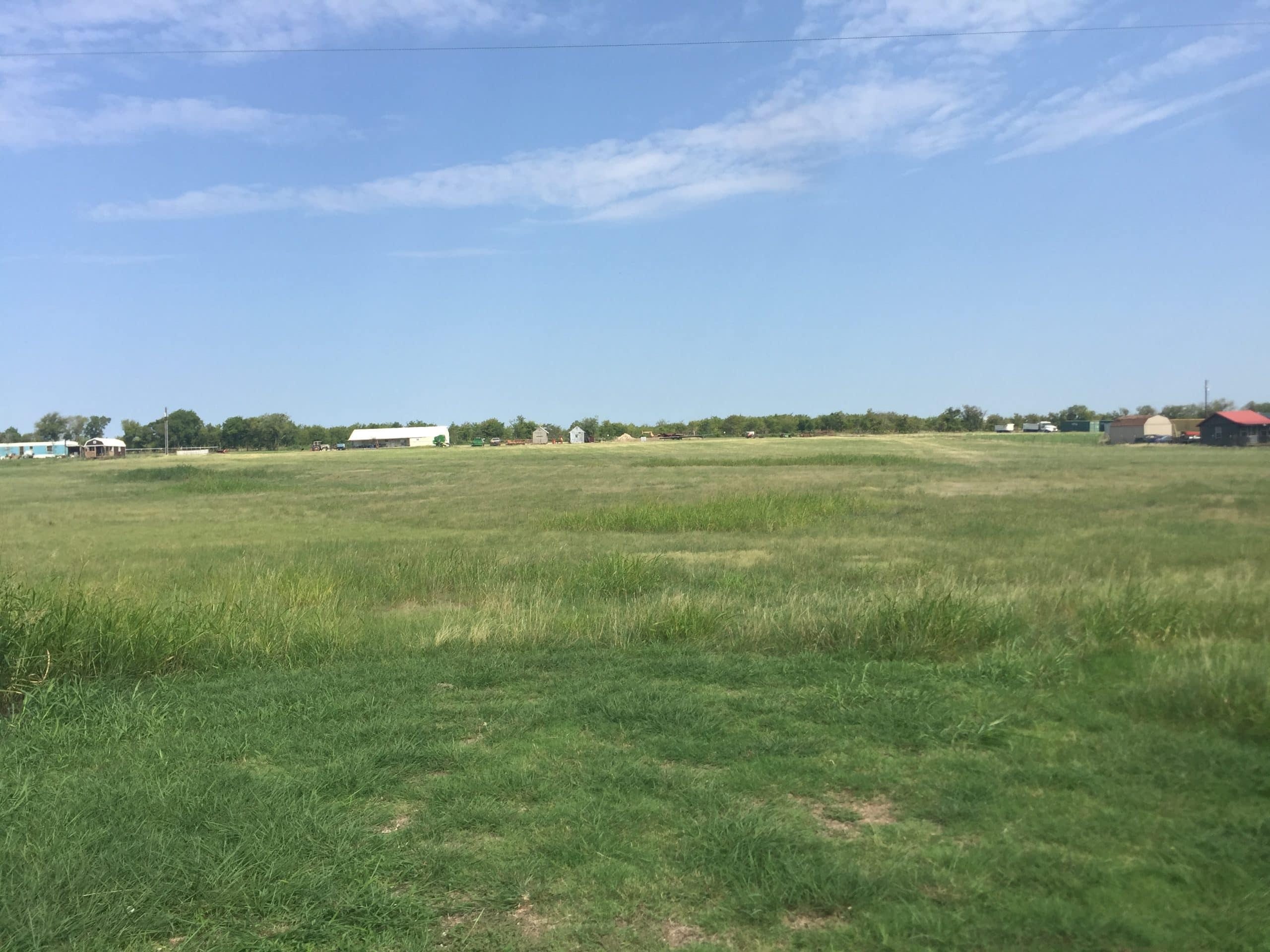 Open field in Hillsboro, West, Texas, ideal for real estate development or farming.