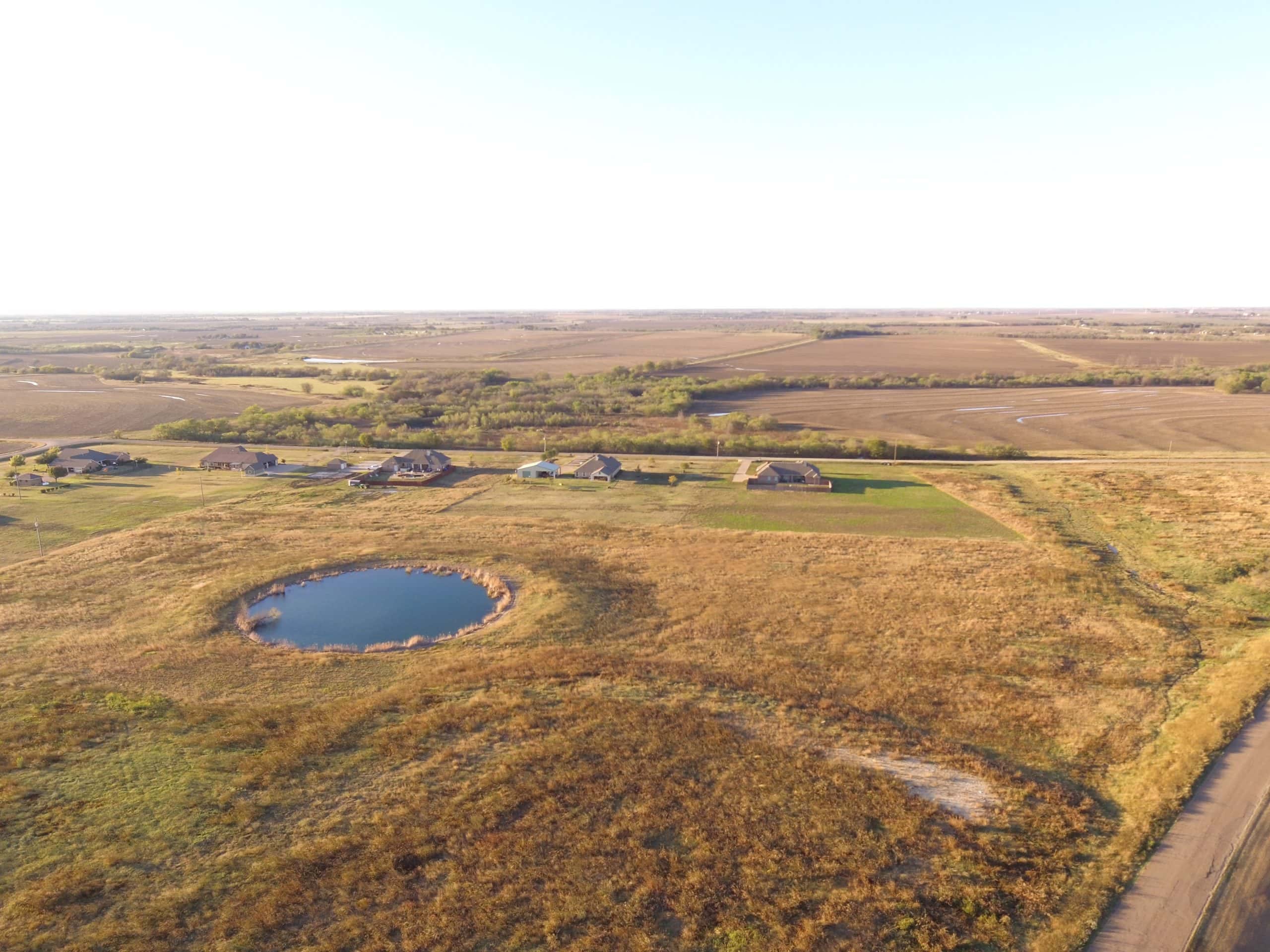 Aerial view of open farmland and a small pond near Hillsboro, Texas.