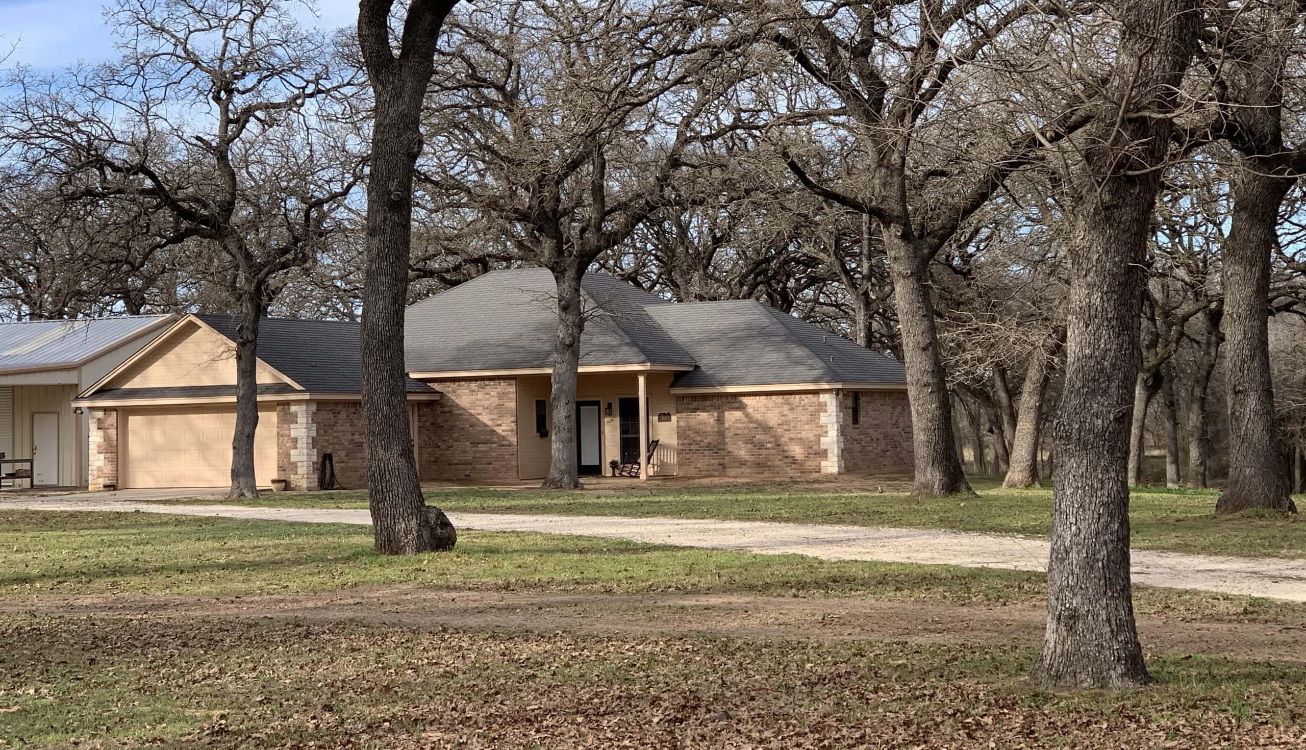 House in Hillsboro, West Hill County, Texas, surrounded by mature trees.