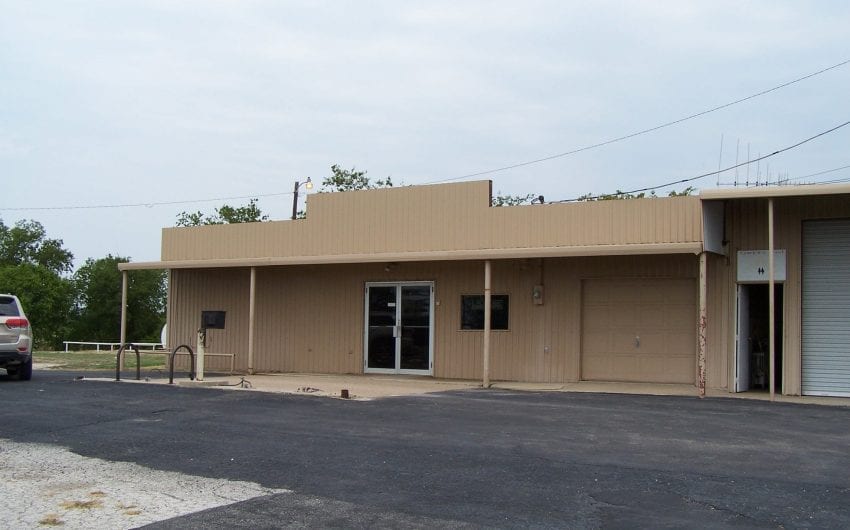 Story structure with beige siding and a flat roof.