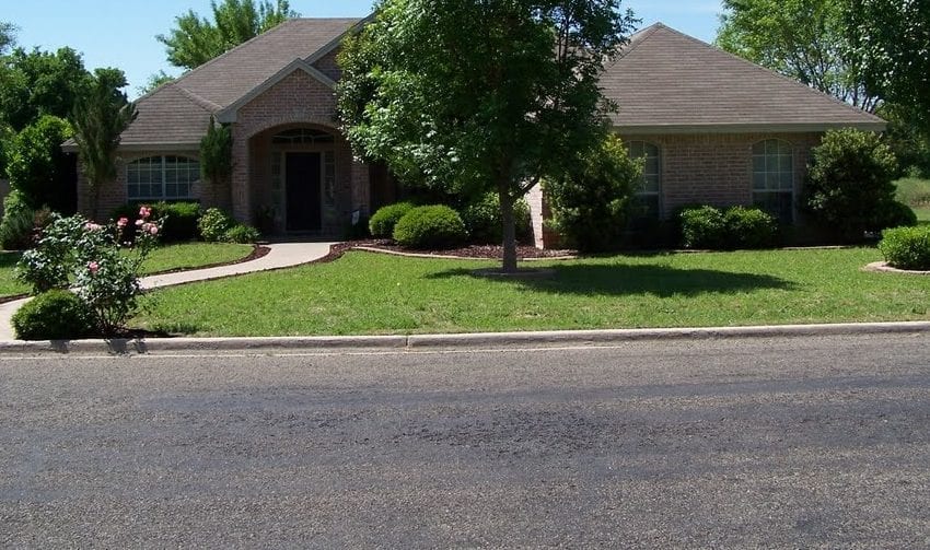 Beautiful brick home in Hillsboro, West, with lush landscaping and a welcoming front yard.